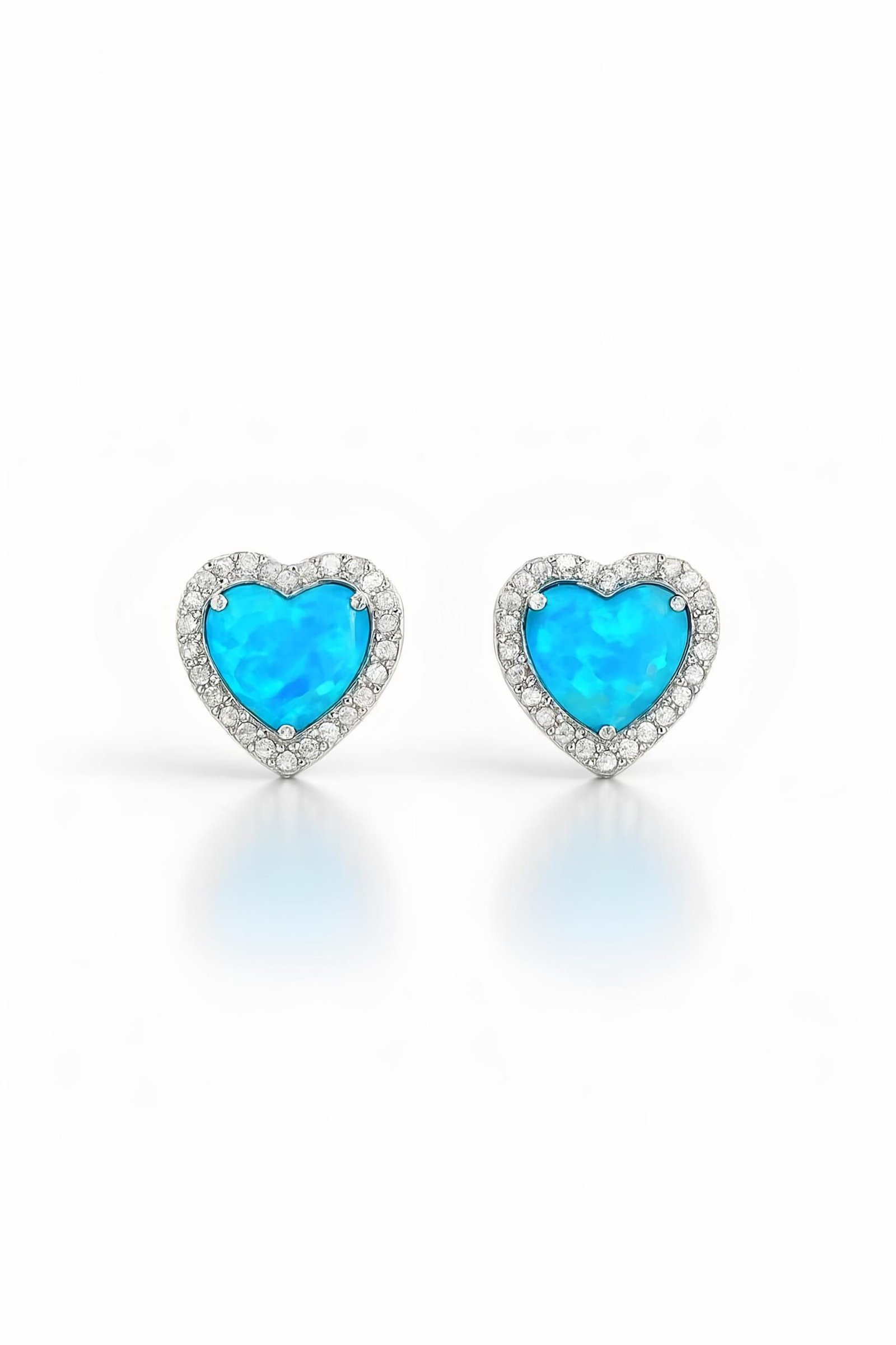 Pair of Silver CZ & Blue Opal Heart Stud Earrings on white background